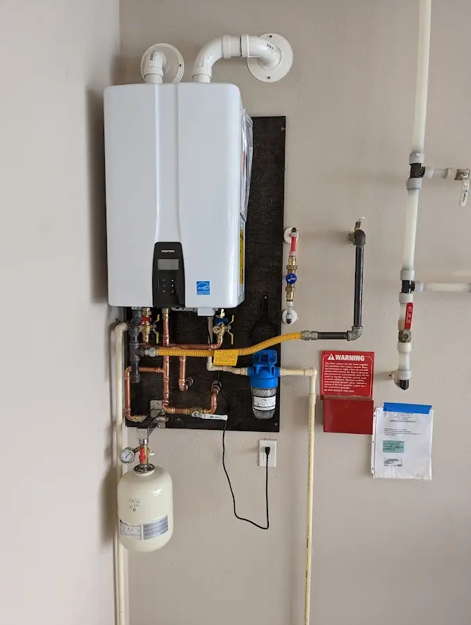 Professional plumber installing copper piping in a Clive home